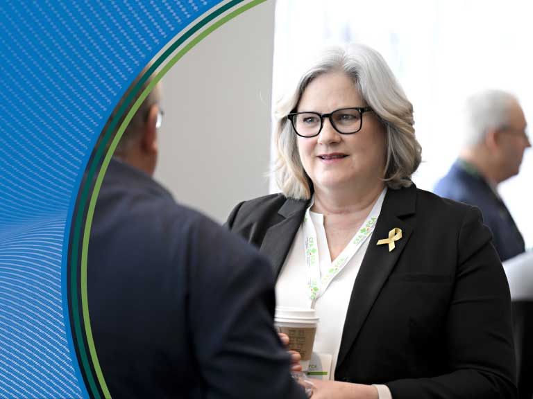 Protective woman with gray hair and glasses at Canadian Agricultural Safety Association event.