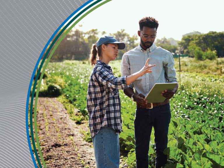 Agricultural safety training with a woman and man in a field.