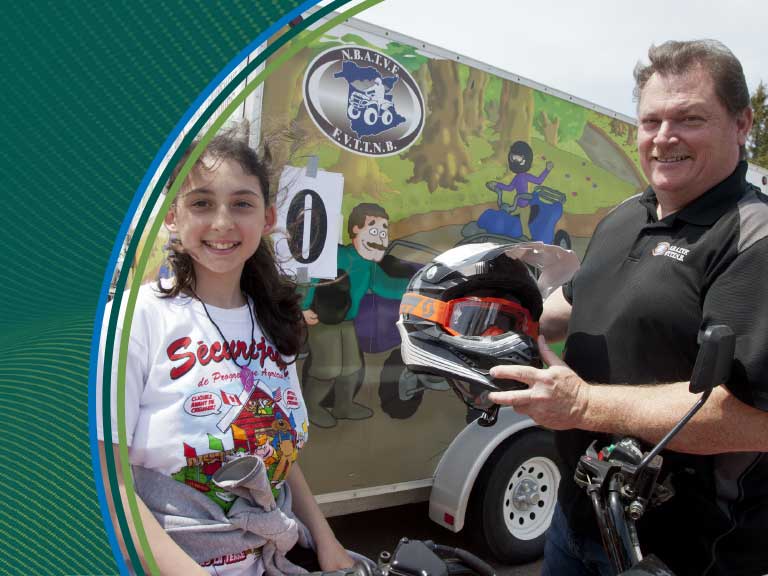 Protective motorcycle gear safety demonstration at Canadian Agricultural Safety Association event.
