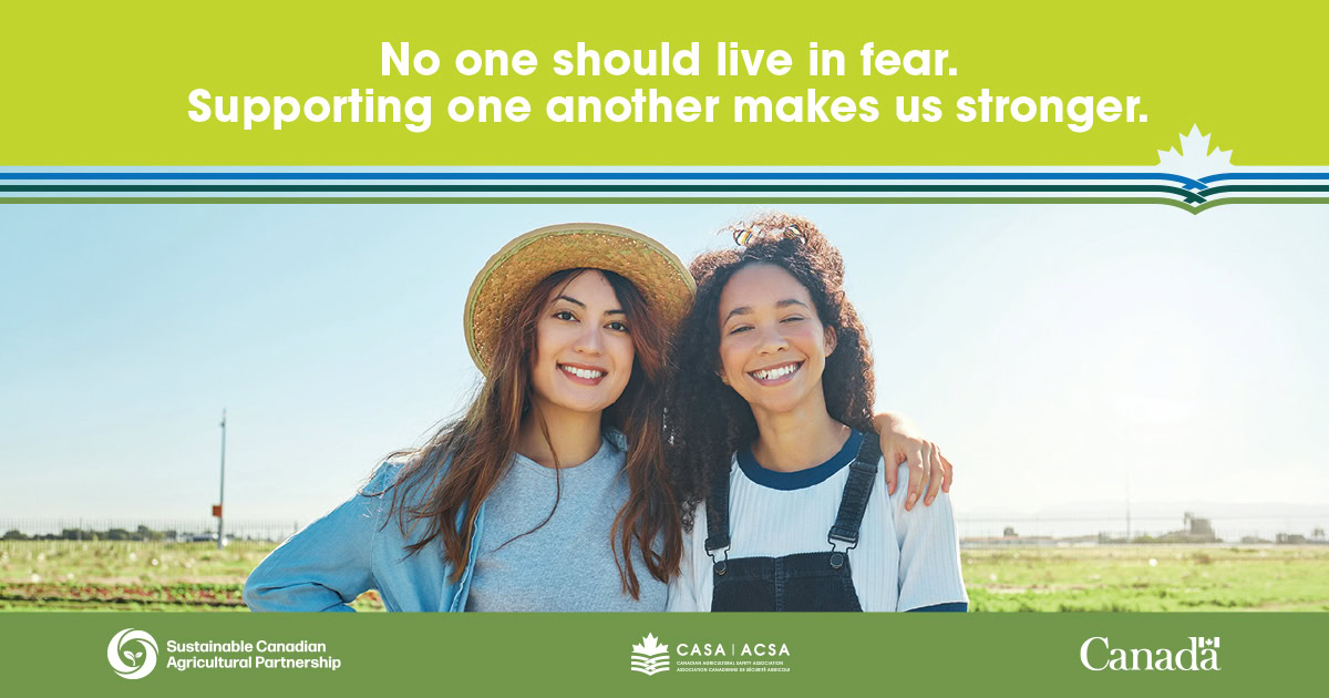 Two smiling women in a field, promoting agricultural safety and support.